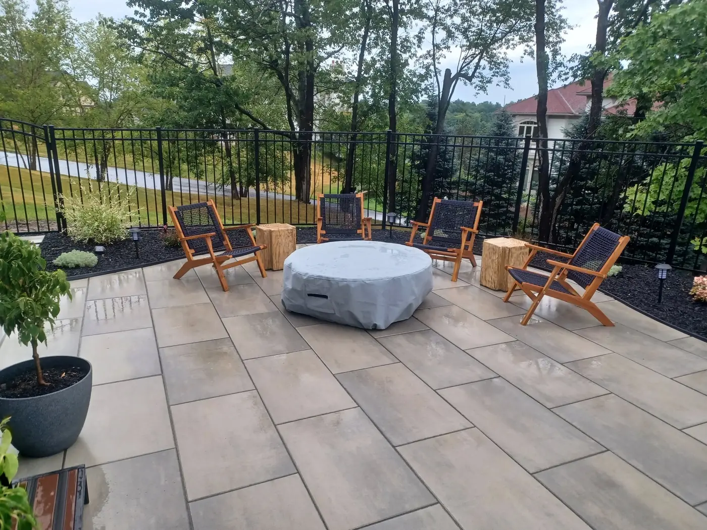 Large paver patio with a seating area and landscape beds